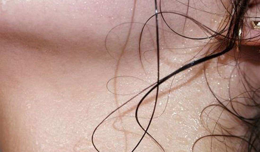 Image of sweat on woman's neck