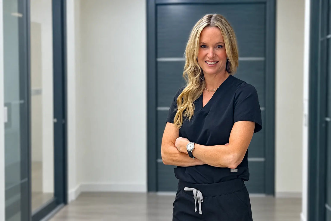 Dr. Julie Karen wearing scrubs standing in her office.